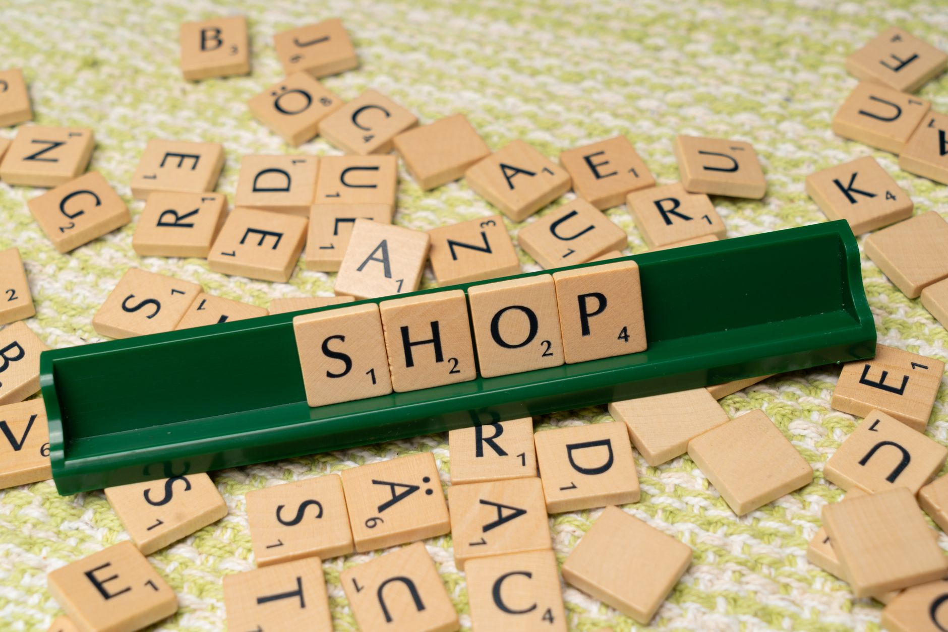 scrabble tiles spelling the word shop