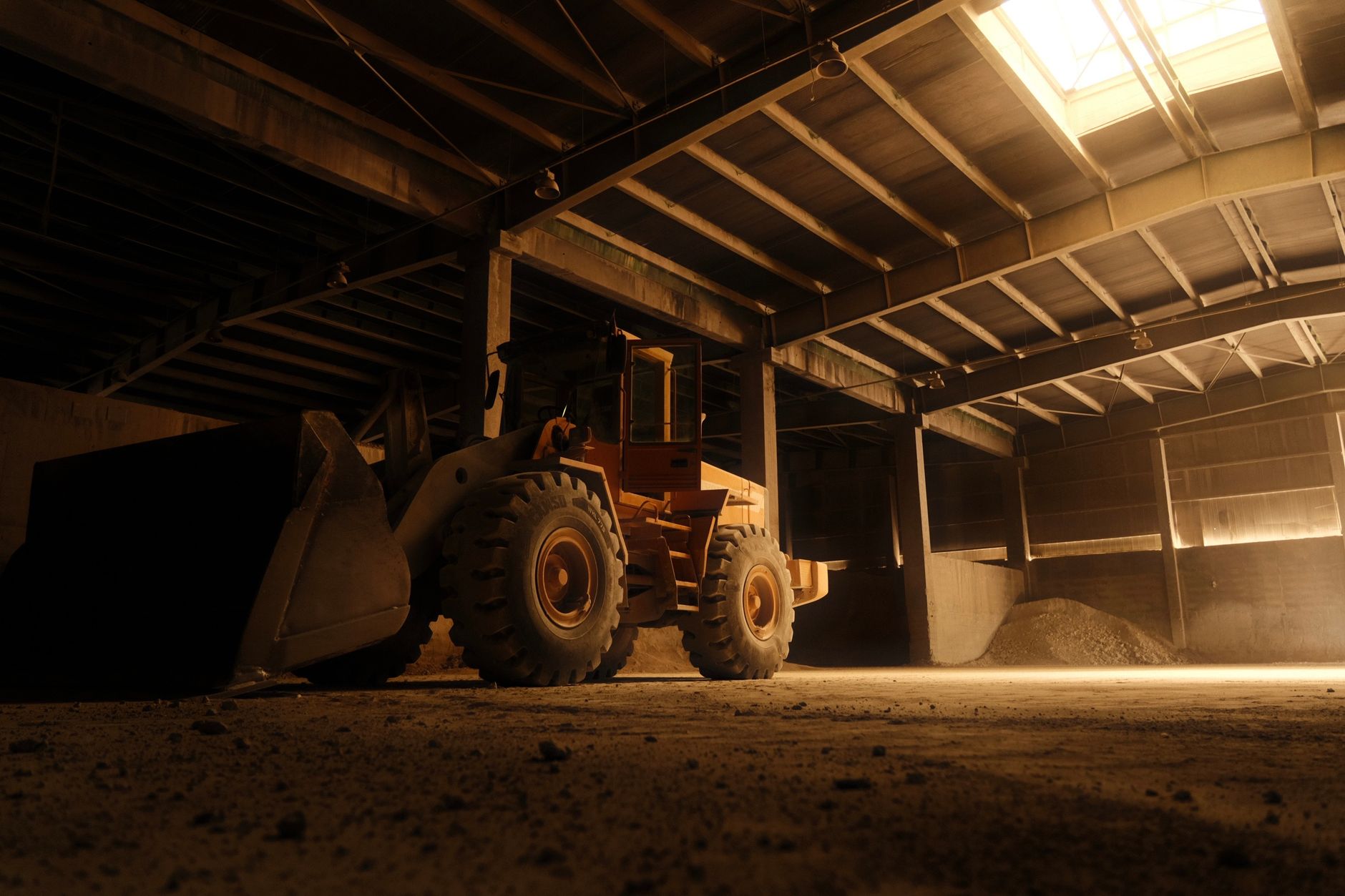 a large tractor is parked in a warehouse